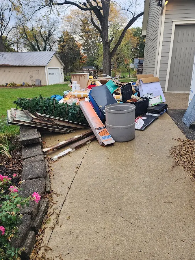 Dumpster being loaded with debris for Estate Cleanout Dumpster Rental in St. Petersburg